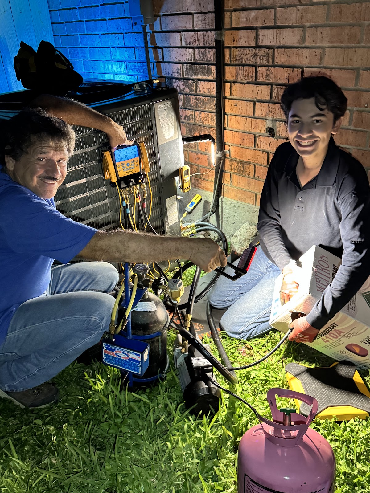 Mundo HVAC technicians servicing an AC unit in McAllen